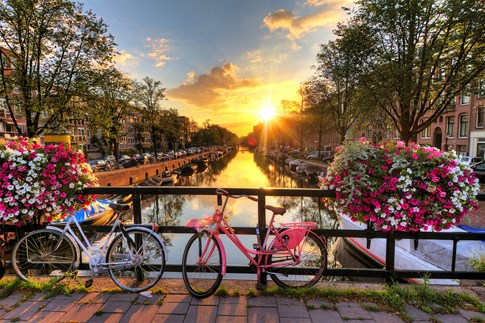 Amsterdam bicycles and canal at sunrise, Netherlands