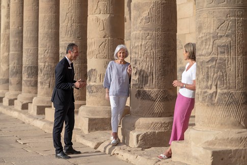 Tour director with two guests at pillars, Egypt