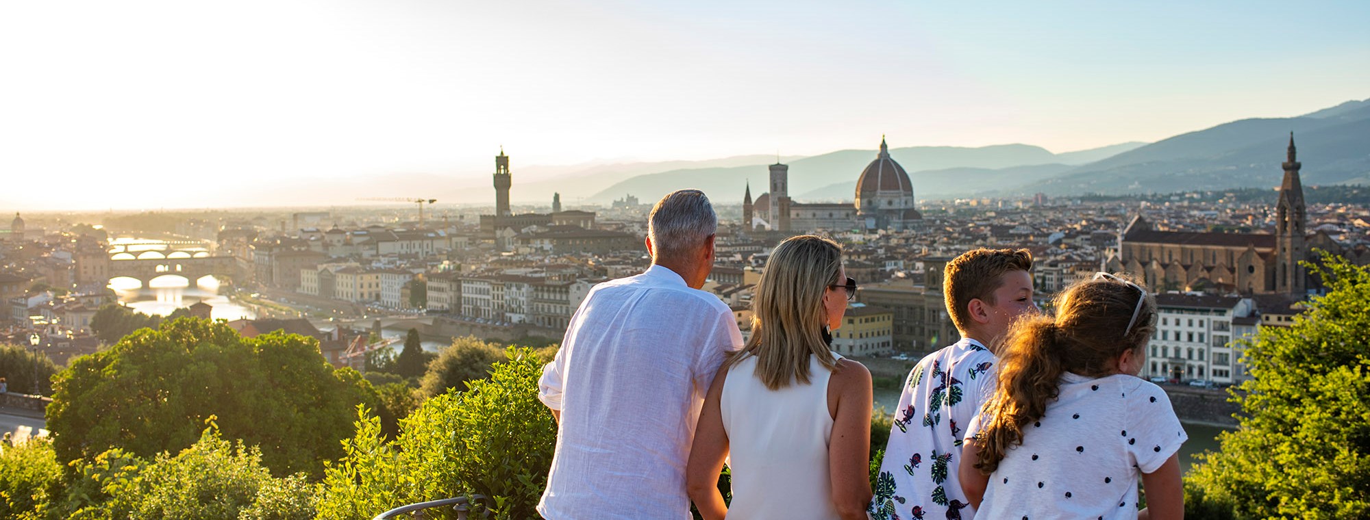 Four family members looking at Florence cityscape, Italy