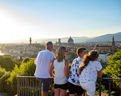 Four family members looking at Florence cityscape, Italy