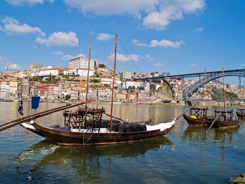 Wine barrels on boat in river in Porto, Portugal