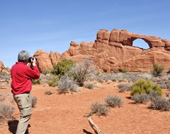 Man taking picture at Arches National Park, Utah 