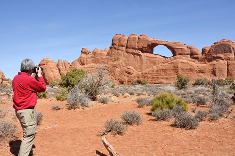 Man taking picture at Arches National Park, Utah 