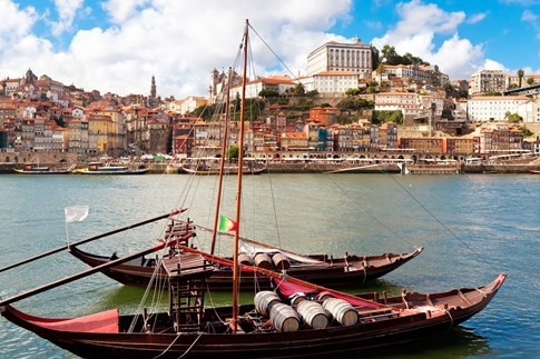 Two boats on Douro River with Porto in background, Portugal