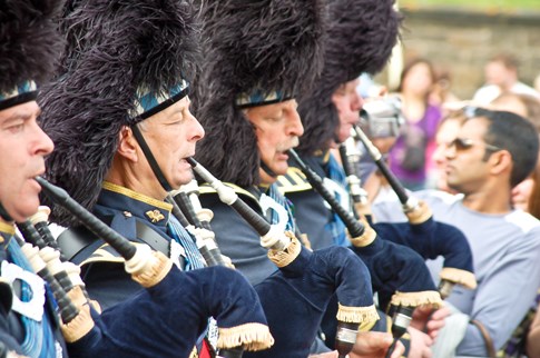 Close up of bagpipers in blue, Scotland