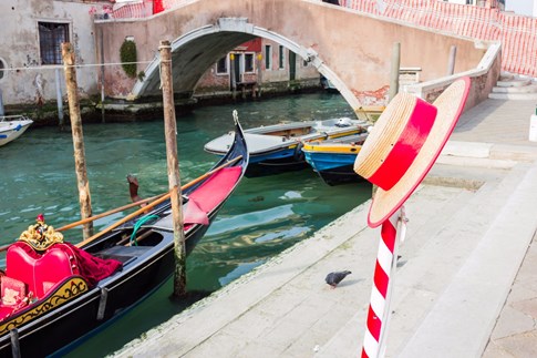 Gondola and hat hanging on pole, Venice, Italy