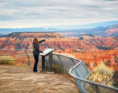 Woman pointing on observation deck in Grand Canyon, Arizona
