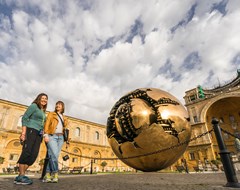 Two people with ball in Vatican courtyard, Italy