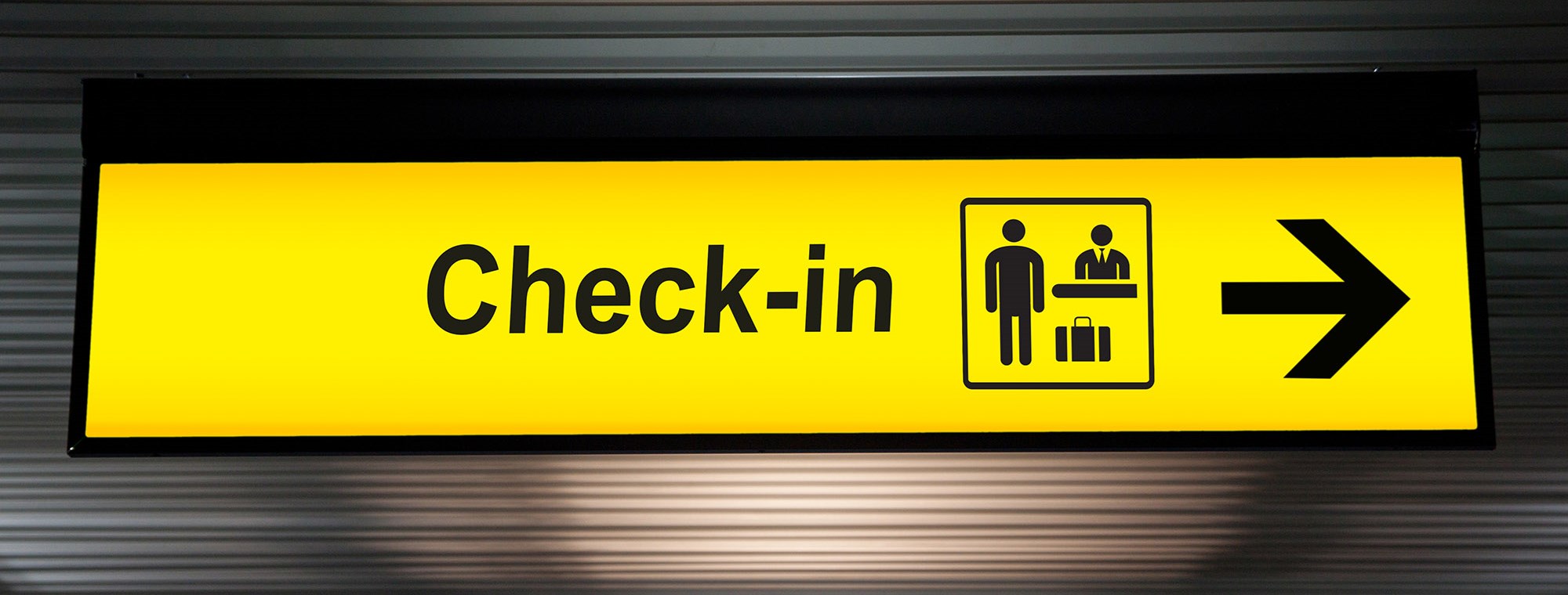 airport-check-in-sign-with-arrow-yellow.jpg