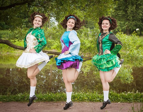Three female Irish dancers jumping
