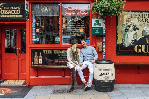 Couple sitting outside Temple Bar in Dublin, Ireland