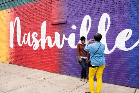 Tourists taking picture by rainbow wall in Nashville, Tennessee