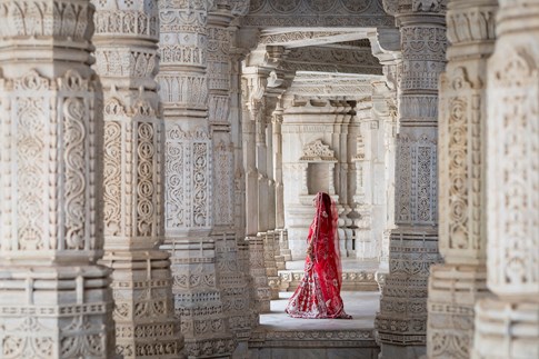 Woman in red sari standing in Jain Temples, India