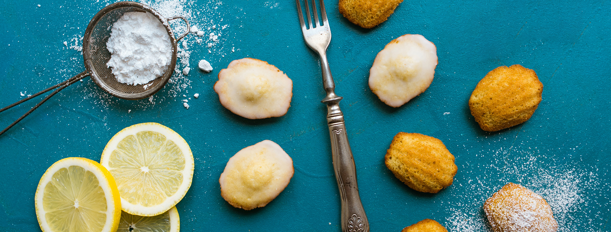 Recipe Expert French Madeleins Back Lemons Flour Sift Fork Teal Background