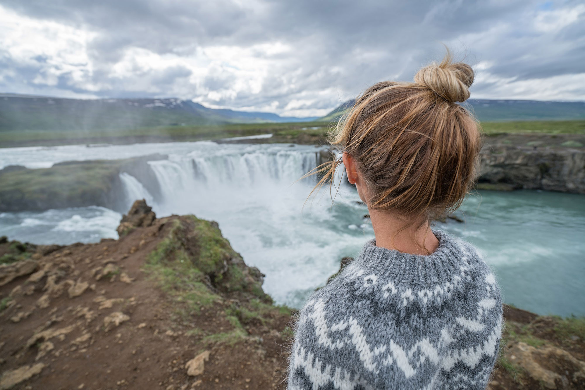 Iceland Waterfall Woman In Knit Sweater Watching From A Distance