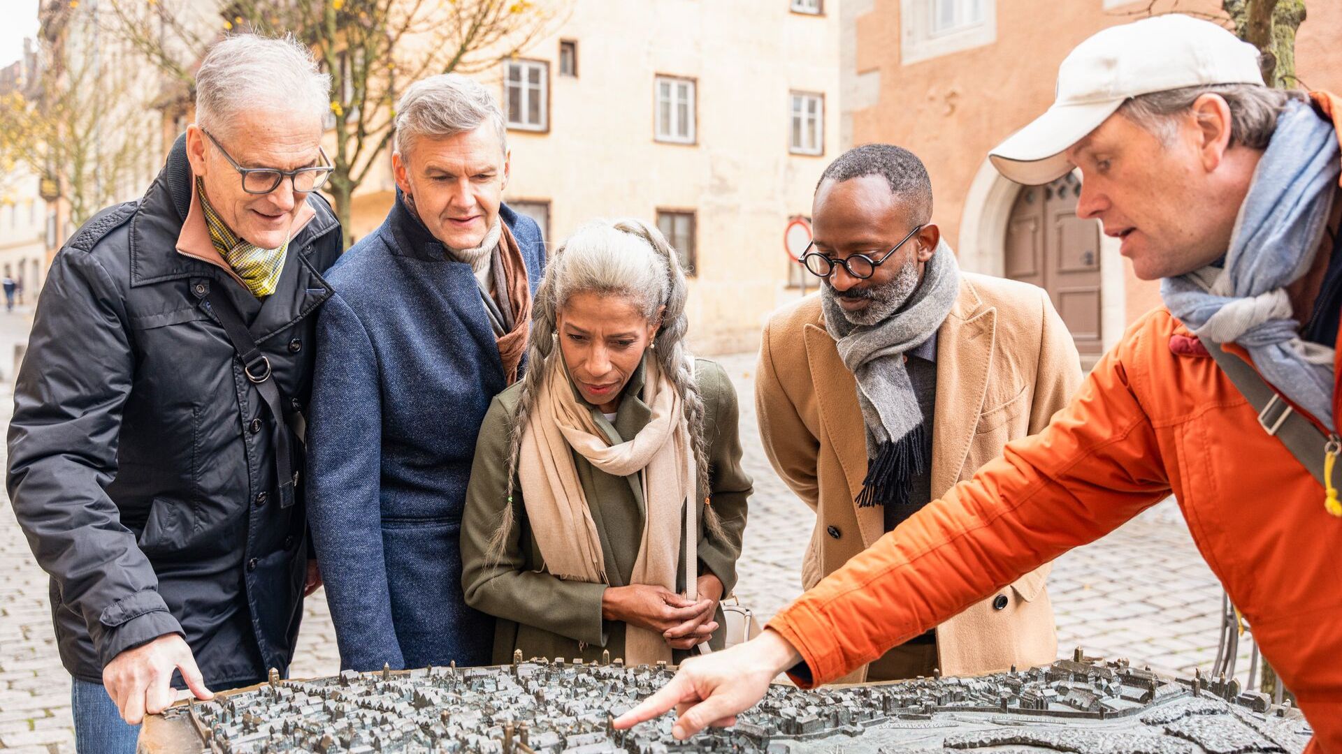 Tour Guide Points Out Detail Of Model Tour Director