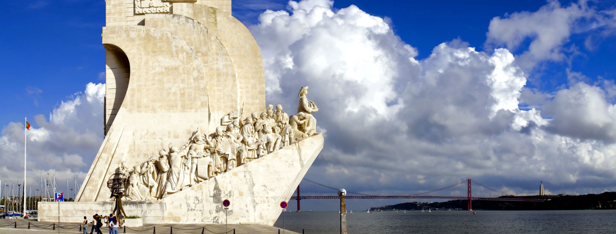 Portugal Lisbon Monument To Discoveries With Dark Blue Sky And Clouds