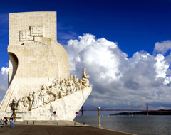 Portugal Lisbon Monument To Discoveries With Dark Blue Sky And Clouds