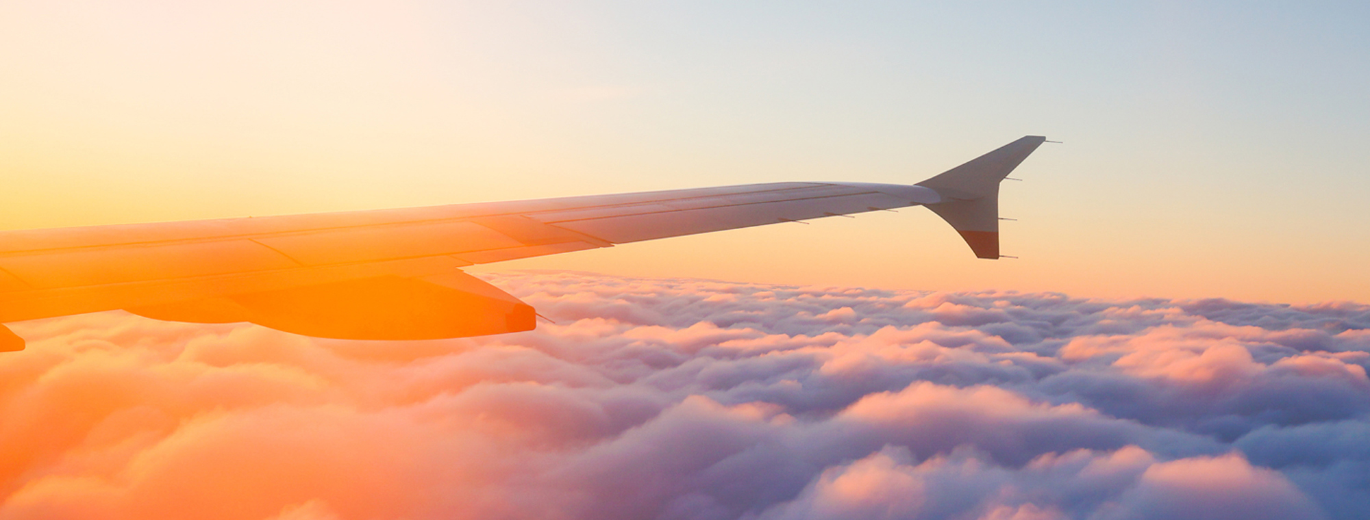Airplane Wing Above Clouds